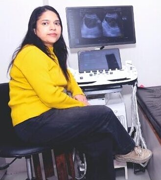 Dr Kajli Gupta beside the ultrasound machine